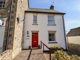A house with a red door and windows at Morpeth in Combe St Nicholas