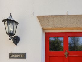 A door with a lamp and nameplate at Morpeth in Combe St Nicholas