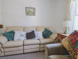 A living room with a sofa and cushions at Morpeth in Combe St Nicholas
