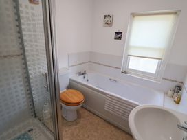 A bathroom with a shower, bathtub, toilet, and sink at Morpeth in Combe St Nicholas