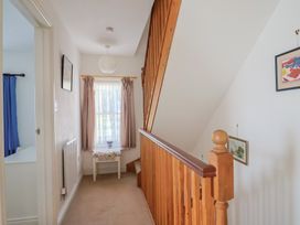 A hallway with a staircase and window at Morpeth in Combe St Nicholas
