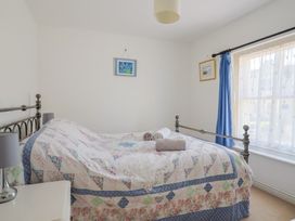 A bedroom with a bed and bedside table at Morpeth in Combe St Nicholas