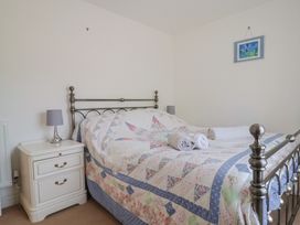 A bedroom with a bed and bedside table at Morpeth in Combe St Nicholas