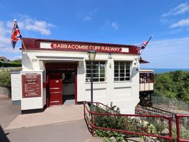 A building with a sign and railway car at Babbacombe Cliff Railway in Torquay