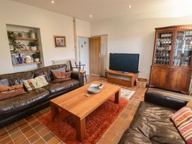 A living room with a sofa and coffee table at No.8 Millmoor Farm Cottage Broad Haven