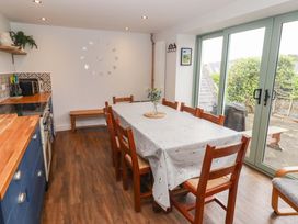 A dining room with a table and chairs at No.8 Millmoor Farm Cottage in Broad Haven