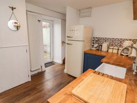 A kitchen with refrigerator and countertop at No.8 Millmoor Farm Cottage Broad Haven