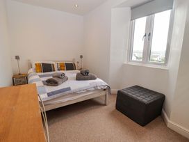 A bedroom with a bed and window at No.8 Millmoor Farm Cottage Broad Haven