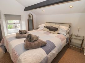 A bedroom with a bed and nightstand at No.8 Millmoor Farm Cottage in Broad Haven