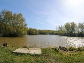 A view of a lake surrounded by trees at Lodge 1 - Bron Eifion Criccieth