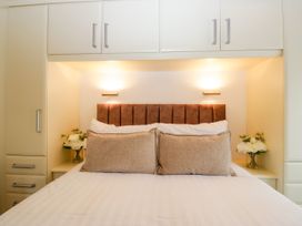 A bedroom with a bed and pillows at Fox Red Retreat in Troutbeck Bridge