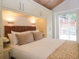 A bedroom with a bed and wardrobe at Fox Red Retreat in Troutbeck Bridge