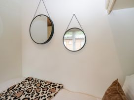 A bedroom with mirrors and a leopard print blanket at Fox Red Retreat in Troutbeck Bridge