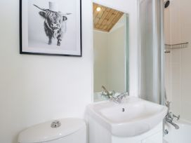 A bathroom with a sink, toilet, and shower at Fox Red Retreat in Troutbeck Bridge