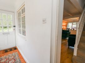 A hallway with a door and staircase at 12 West Street Weymouth