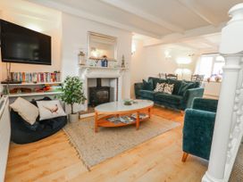 A living room with a fireplace and sofa at 12 West Street in Weymouth
