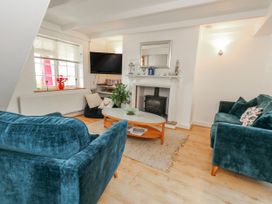 A living room with sofa and television at 12 West Street, Weymouth