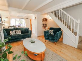 A living room with seating and staircase at 12 West Street in Weymouth