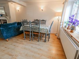 A dining room with a table and chairs at 12 West Street in Weymouth