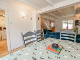 A dining room with a table and chairs at 12 West Street Weymouth