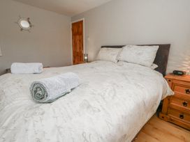 A bedroom with a bed and towels at 12 West Street Weymouth