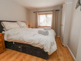 A bedroom with a bed and wardrobe at 12 West Street Weymouth