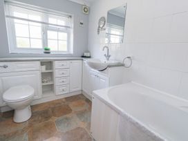 A bathroom with a bathtub and sink at 12 West Street Weymouth