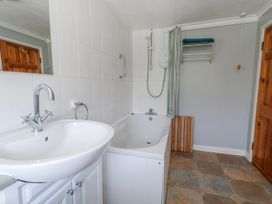 A bathroom with a bathtub and sink at 12 West Street Weymouth
