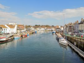 A harbor with boats and buildings at 12 West Street Weymouth