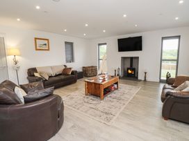A living room with sofas and a fireplace at Ty Hebog 