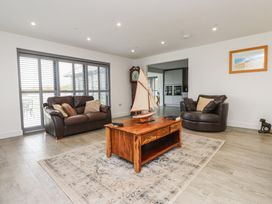 A living room with a sofa and armchair at Ty Hebog 