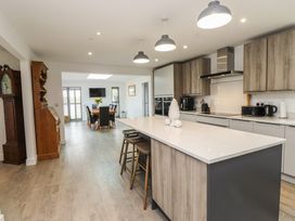 A kitchen with an island and dining area at Ty Hebog in 