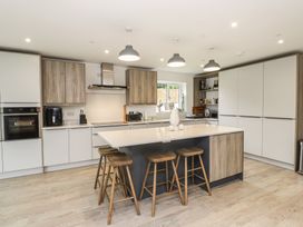 A kitchen with cabinets and a kitchen island at Ty Hebog in 