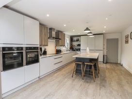A kitchen with cabinets and a kitchen island at Ty Hebog in 