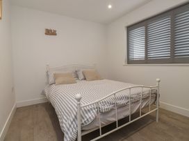 A bedroom with a bed and window at Ty Hebog