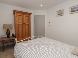A bedroom with a bed and wardrobe at Ty Hebog
