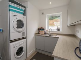A laundry room with a washing machine and dryer at Ty Hebog