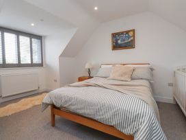 A bedroom with a bed and window at Ty Hebog