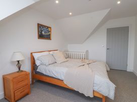 A bedroom with a bed and crib at Ty Hebog in 