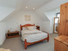 A bedroom with a bed and nightstands at Ty Hebog in 
