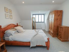 A bedroom with a bed and wardrobe at Ty Hebog in 
