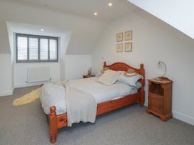 A bedroom with a bed and bedside table at Ty Hebog 