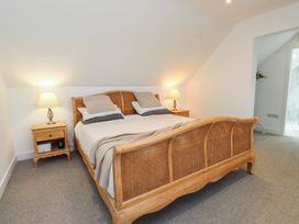 A bedroom with a bed and nightstand at Ty Hebog