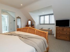 A bedroom with a bed and a dresser at Ty Hebog