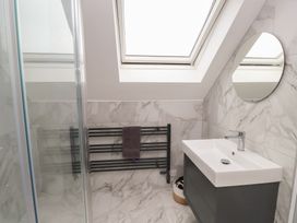 A bathroom with a shower and a sink at Ty Hebog