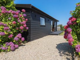 A house with flowers and a path at Wisteria Lodge in Redruth