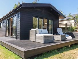 An outdoor area with a house and furniture at Wisteria Lodge Redruth