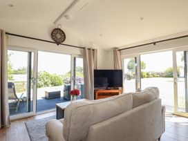 A living room with a television and a sofa at Wisteria Lodge in Redruth