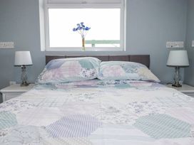 A bedroom with a bed and lamps at Likely Sunset in St. Austell