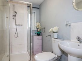 A bathroom with a shower, toilet, and sink at Likely Sunset in St. Austell